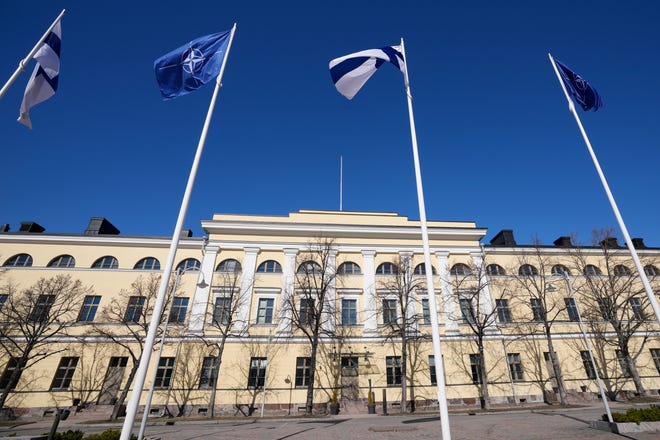 NATO and Finland flags flutter over the building of Ministry of Internal Affairs in Helsinki, Finland, Tuesday, April 4, 2023. Finland prepared to make its historic entry into NATO Tuesday, a step that doubles the Western alliance’s border with Russia and ends decades of non-alignment for the Nordic nation.