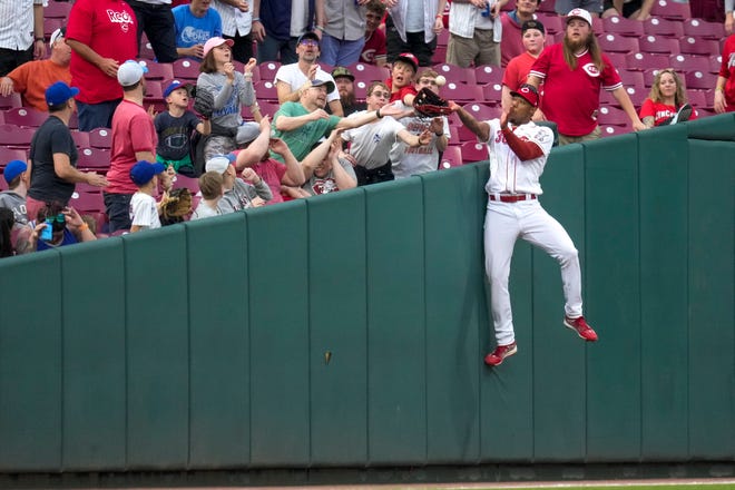 Reds left fielder Will Benson makes a leaping catch in foul territory during the fourth inning Tuesday.