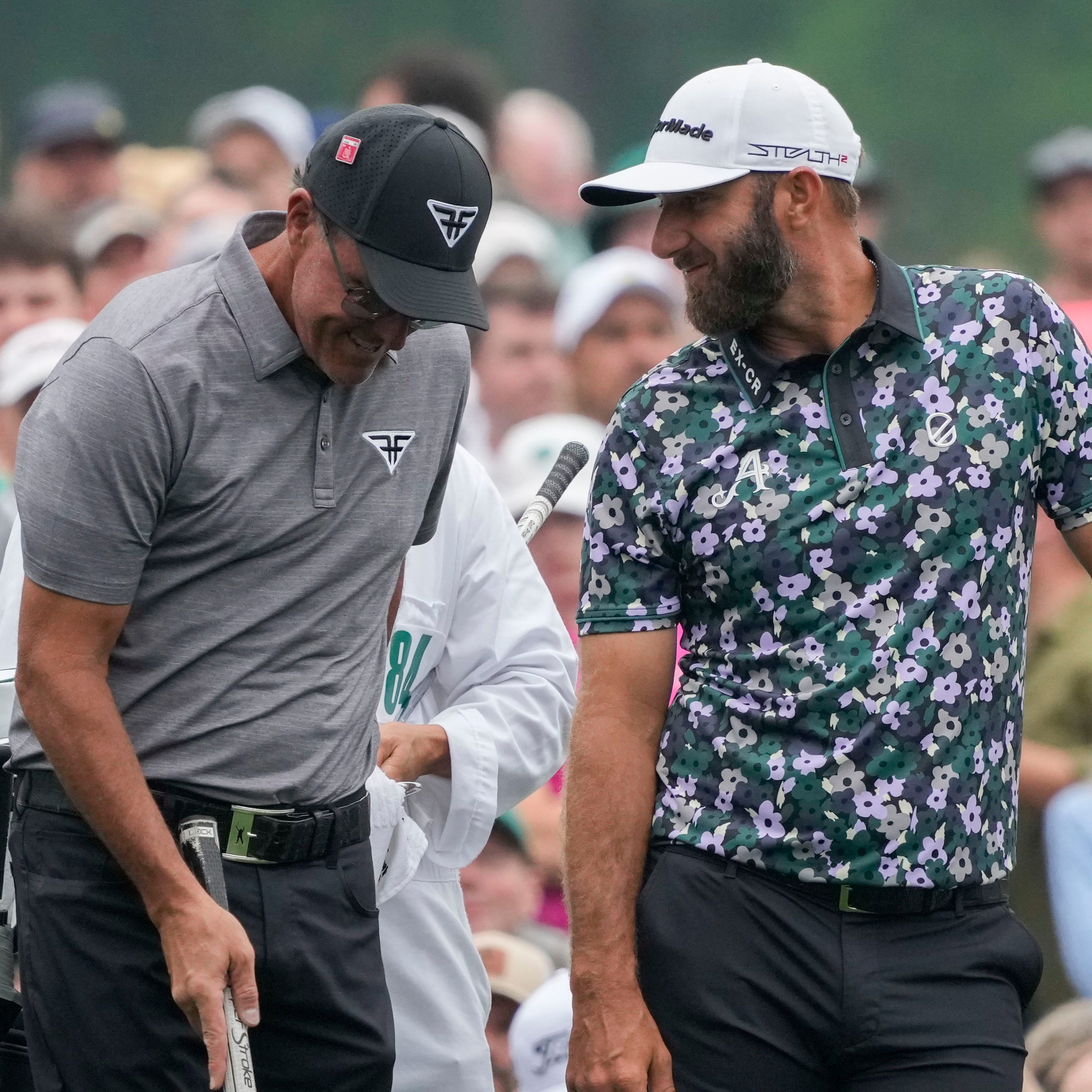 Phil Mickelson and Dustin Johnson share a laugh during a practice round before the Masters.