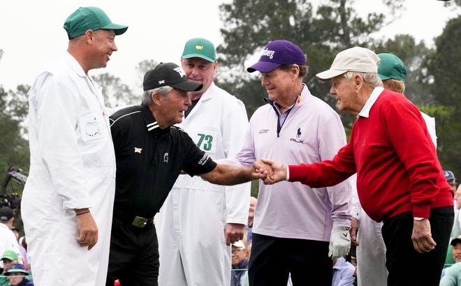 Honorary starters Gary Player, Tom Watson and Jack Nicklaus shake hands on the first tee after teeing off during Thursday's first round of The Masters golf tournament.