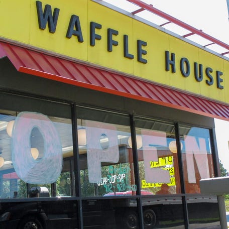 A Waffle House restaurant has "OPEN" painted across its windows on Monday, April 27, 2020 in Savannah, Georgia, as restaurants statewide were allowed to resume dine-in service with restrictions. (AP Photo/Russ Bynum)
