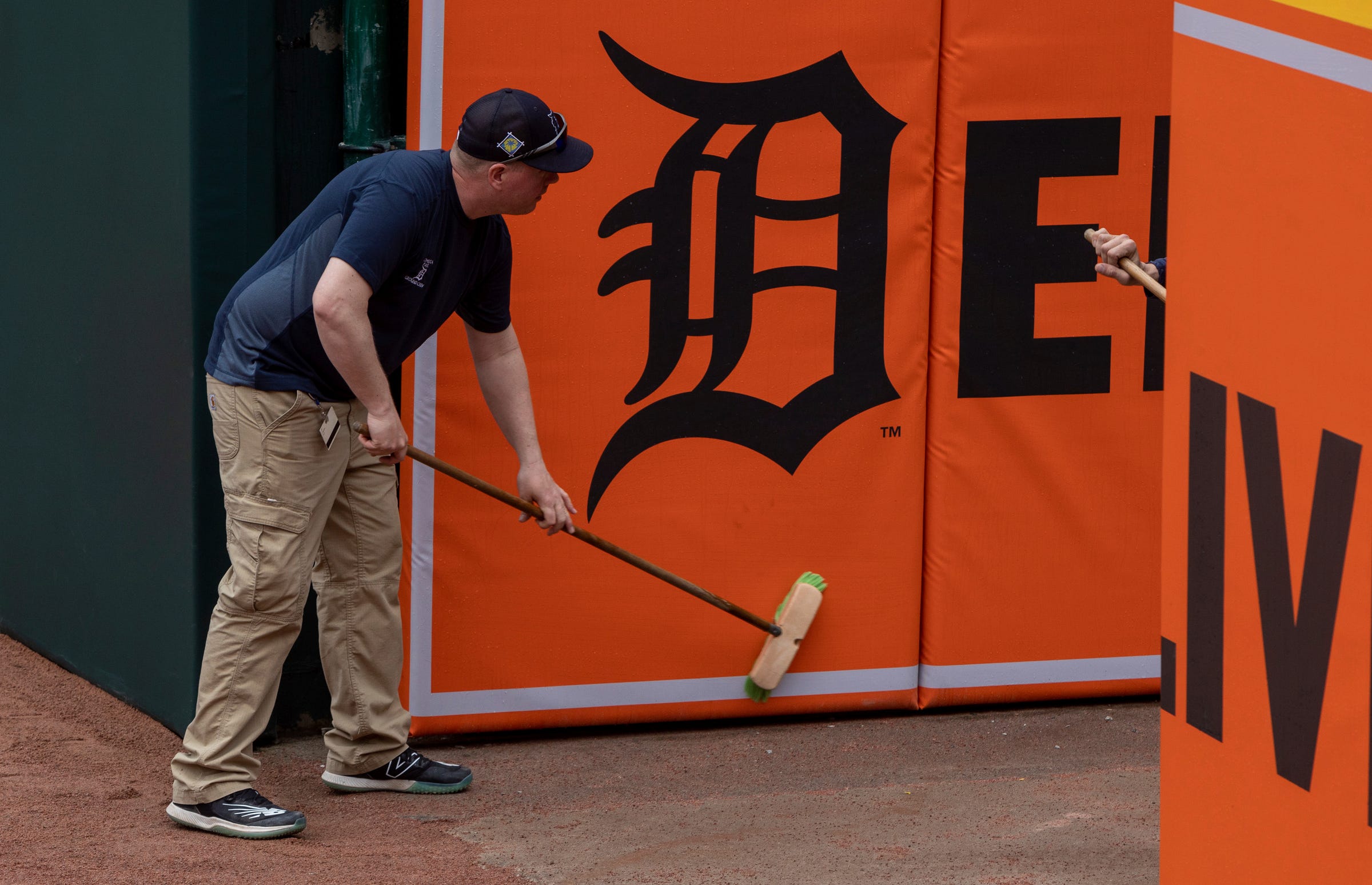 Members of the grounds crew clean the outfield walls during Opening Day preparations inside Comerica Park on Wednesday, April 5, 2023.