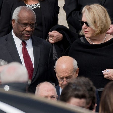 Supreme Court Associate Justice Clarence Thomas, left and his wife Virginia Thomas, right, leave the the Basilica of the National Shrine of the Immaculate Conception in Washington after attending funeral services of the late Supreme Court Associate Justice Antonin Scalia, on Feb. 20, 2016.