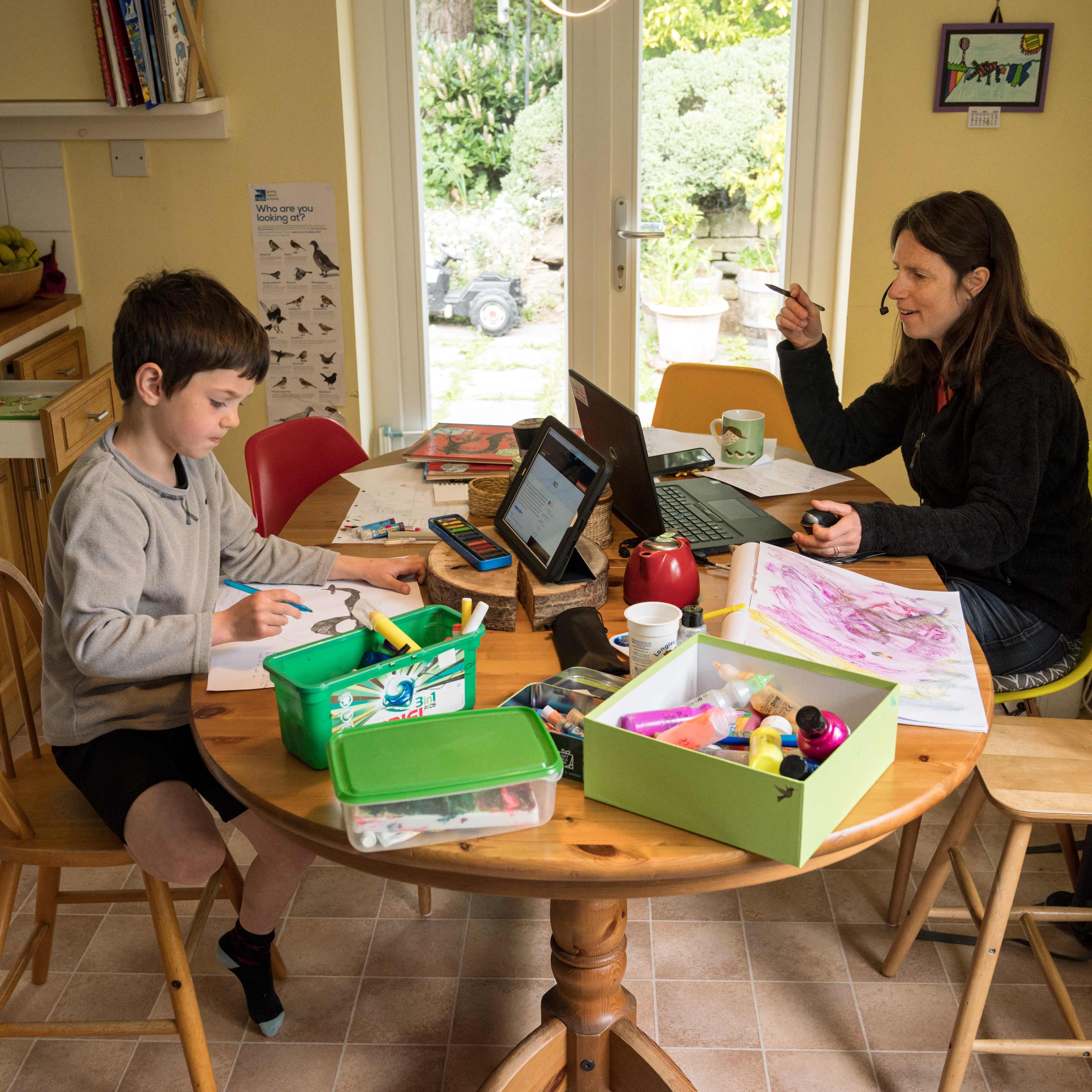 Six-year-old Leo completes a homeschool activity suggested by the online learning website of his infant school, as his mother Moira, an employee of a regional council, works from home in the village of Marsden, near Huddersfield, northern England on May 15, 2020.