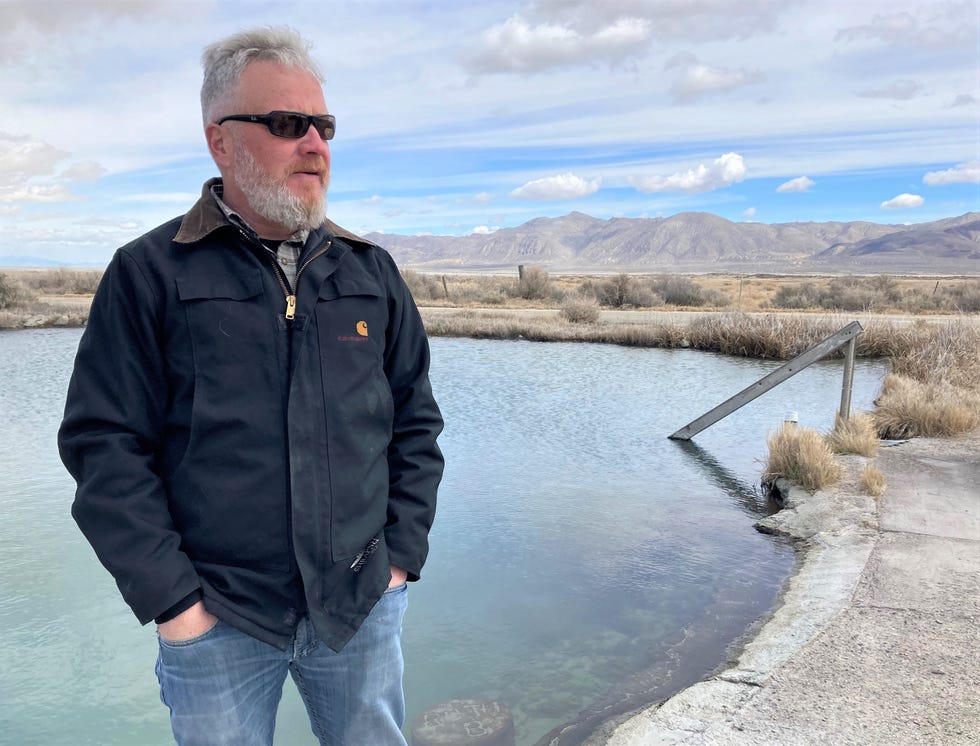 Andy Moore, one of the plaintiffs in a lawsuit against the BLM opposing the project, stands next to a developed pool at Great Boiling Springs.
