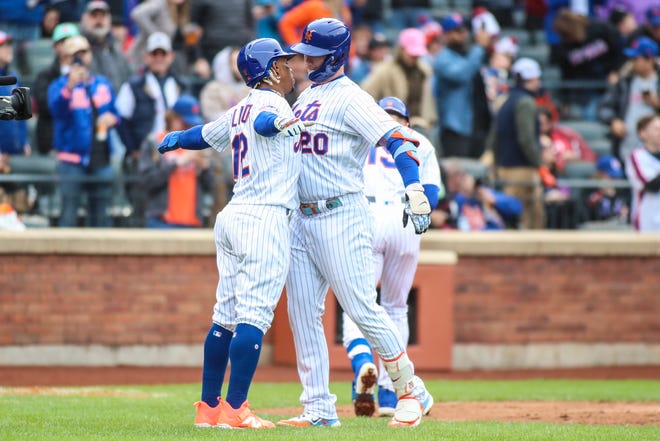 New York Mets designated hitter Pete Alonso (20) celebrates with  shortstop Francisco Lindor (12) after hitting a two run home run in the fifth inning against the Miami Marlins on April 8, 2023, at Citi Field.