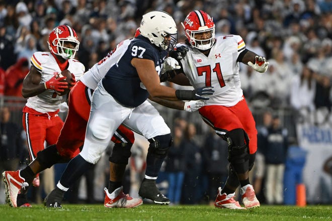 Maryland offensive lineman Jaelyn Duncan (71) looks to block Penn State defensive tackle PJ Mustipher (97) during the first half of an NCAA college football game, Saturday, Nov. 12, 2022, in State College, Pa.