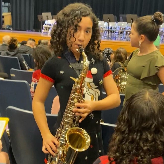 Student Felicia LoAlbo Melendez of Mount Holly with her saxaphone at a school assembly program