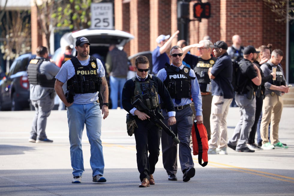 Officers respond to an active shooter at the Old National Bank building Monday in Louisville, Kentucky.