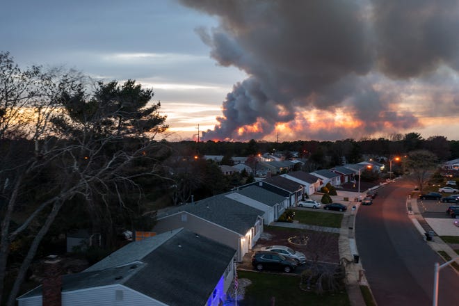 A wildfire burning in Manchester as seen from Carlisle Road in Toms River on Tuesday, April 11, 2023.