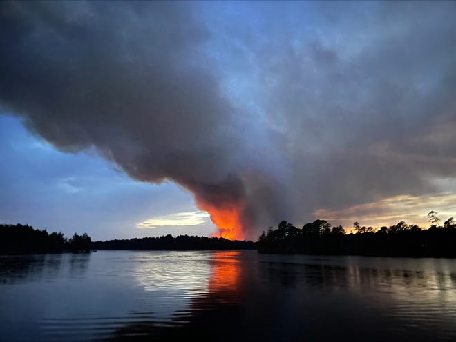 A wildfire that has shut down Route 539 in Ocean County is seen from Lake Horicon in Lakehurst on Tuesday, April 11, 2023.