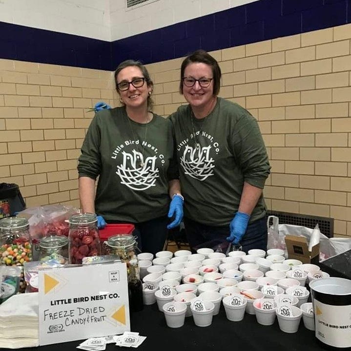 Sandi Long (left) and Molly Olsen (right) serve freeze dried candy and fruit samples at the Dream Center Peoria. Little Bird Nest, LLC can be found at farmers markets and events this summer.
