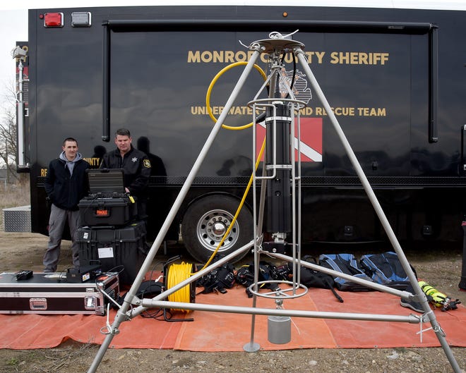 Deputies Mike Stahl and Dave Moore of the Monroe County Sheriff's Office Underwater Dive and Rescue Team make sure the new Kongsberg MS 1000 360-degree sonar machine will connect to a laptop with the Internet before lowering into Lake Monroe.