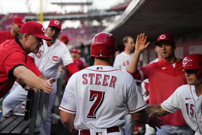 Cincinnati Reds third baseman Spencer Steer returns to the dugout after scoring in the third inning of the MLB National League game between the Philadelphia Phillies and the Cincinnati Reds at Great American Ball Park in downtown Cincinnati on Thursday, April 13, 2023.