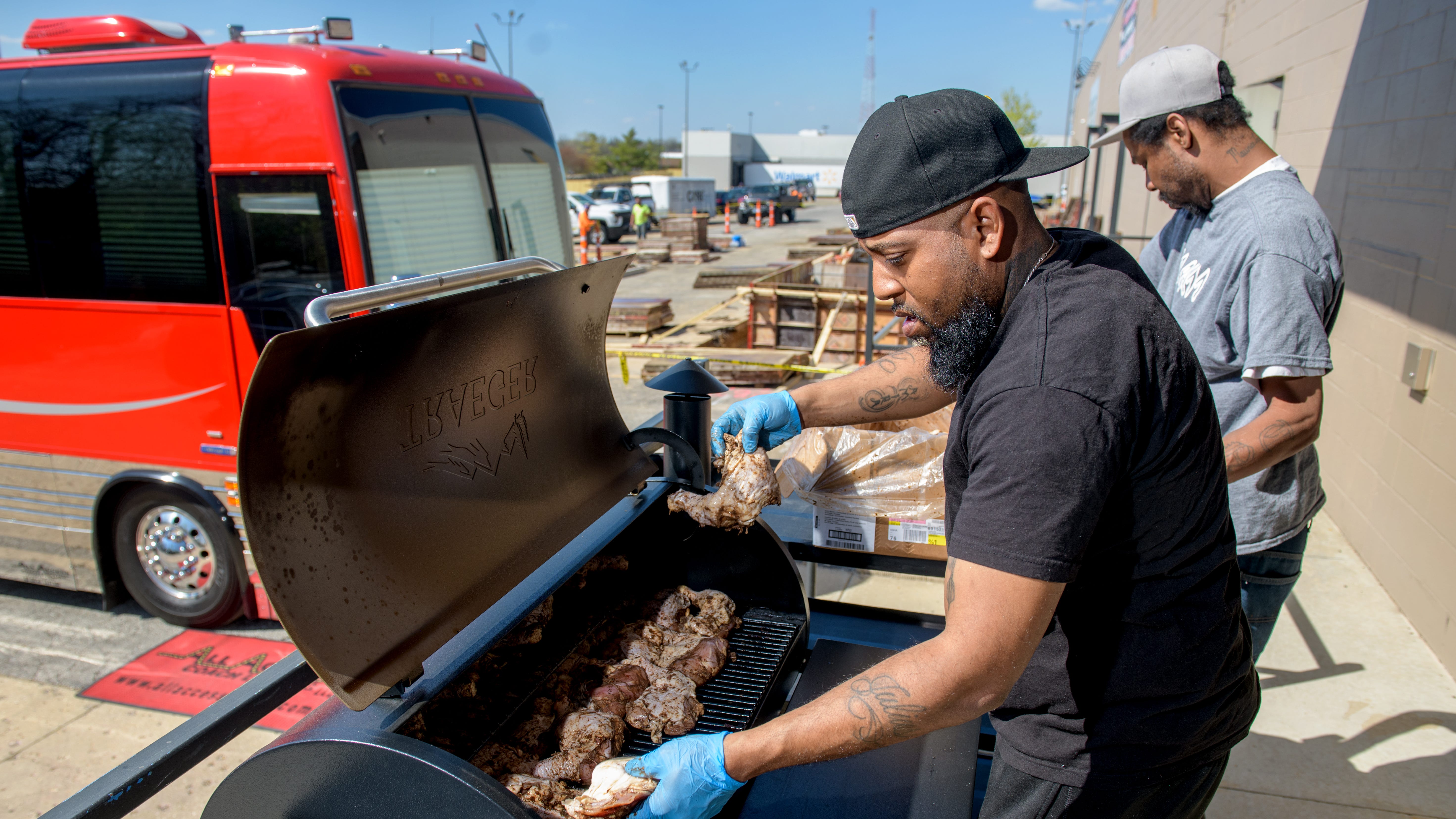 Jeremy Sargent packs a grill with chicken with help from Maurice Campbell outside the Premier Event and Entertainment Center at 3214 N. Dries Lane in Peoria. Sargent's restaurant The Fry Spot closed at its Prospect Road location in 2022 but is now operating out of the venue. Sargent and his wife Cierra are catering events, but will open the restaurant to the public on May 2.
