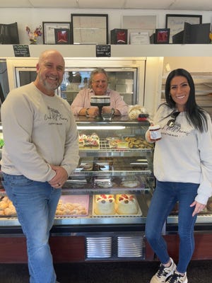 Richard and Carla Bushey, owners of Oak Hill Farms where David Burke (in the background) purchases honey for his Dixie Lee Bakery.