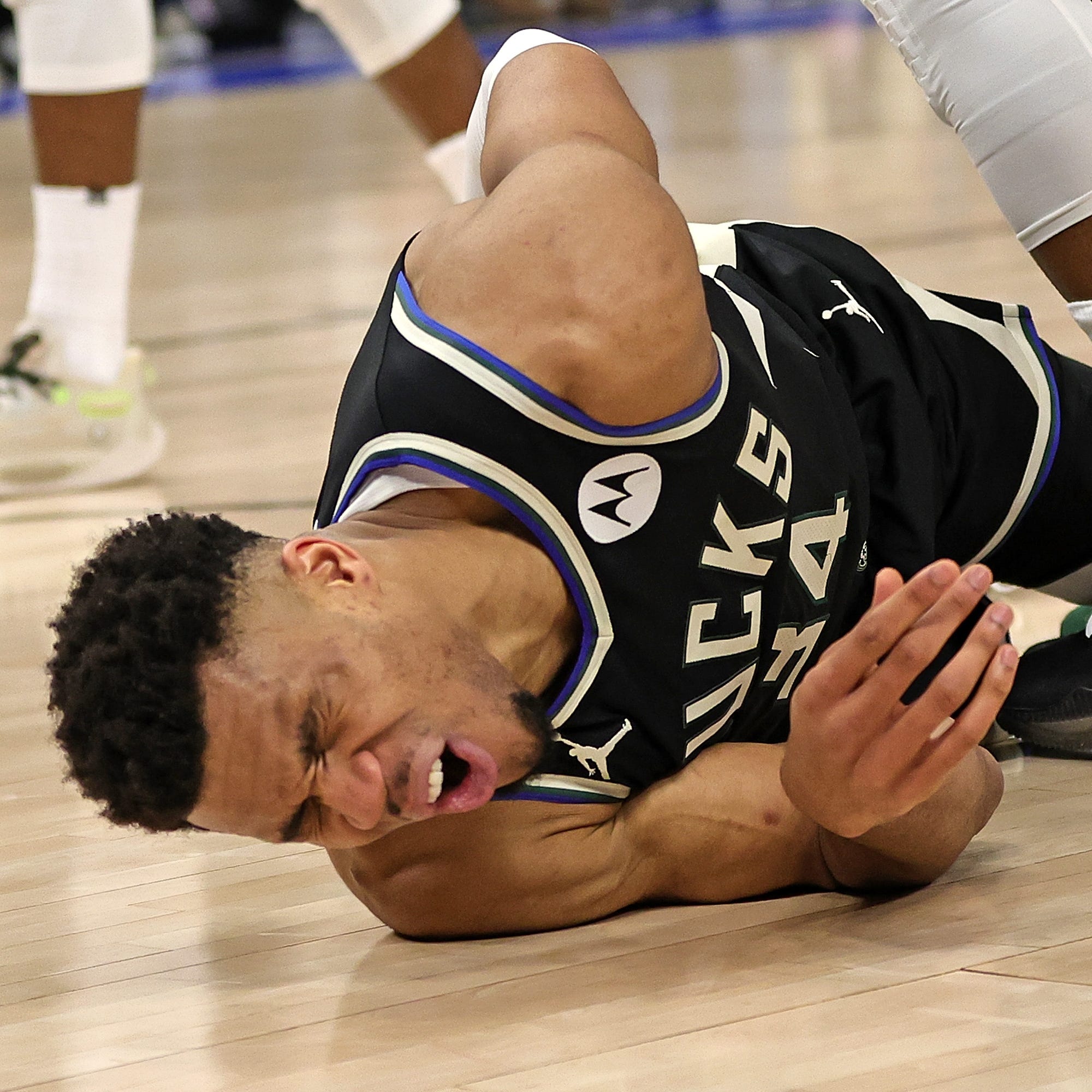 Milwaukee Bucks star Giannis Antetokounmpo injures his lower back against the Miami Heat during Game 1 of their first-round playoff series.