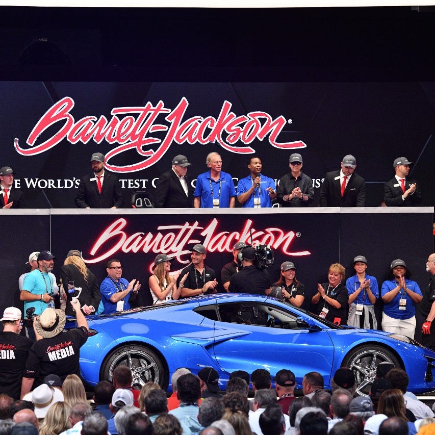 Side profile view of 2024 Chevrolet Corvette E-Ray in Riptide Blue crossing the auction block at the 2023 Barrett-Jackson Palm Beach auction.