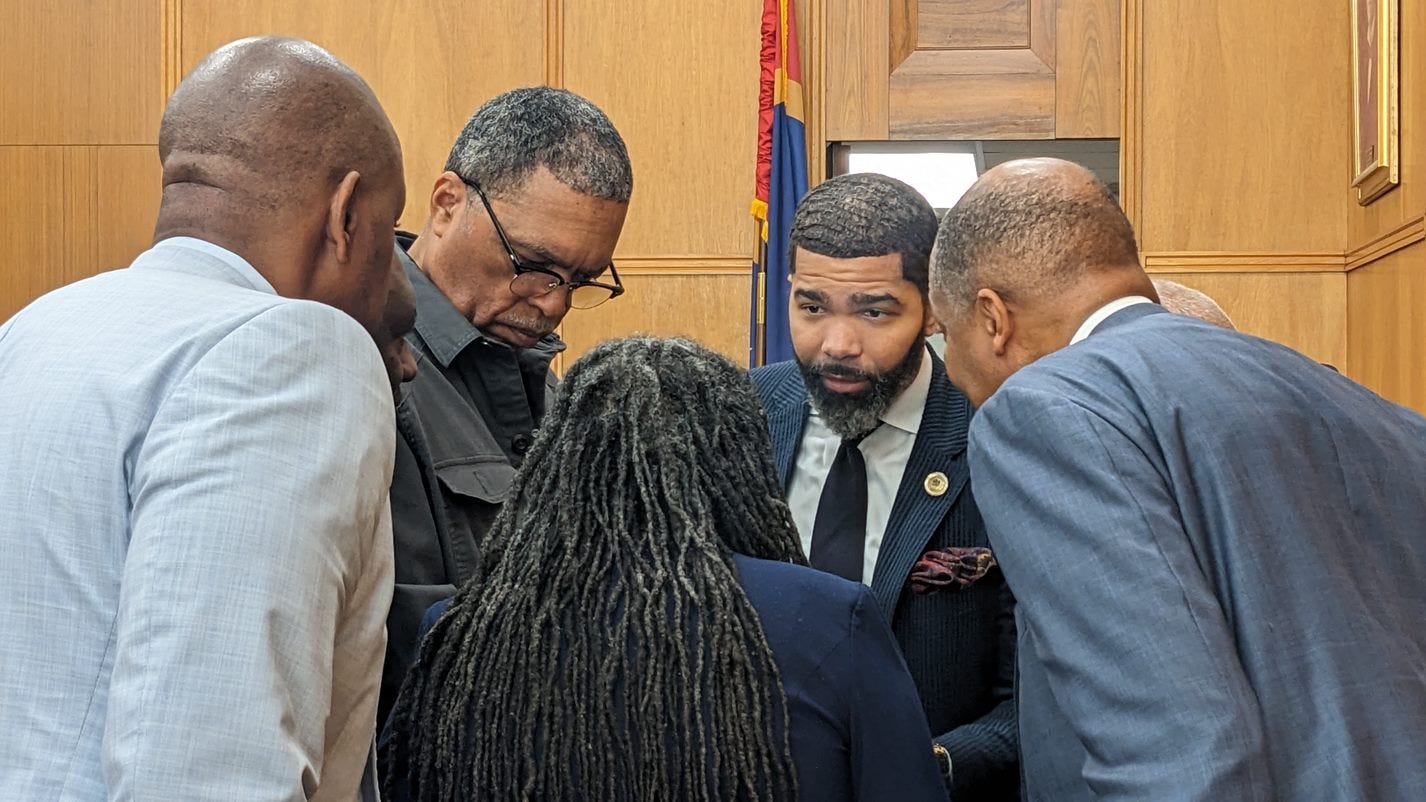 Jackson Mayor Chokwe Antar Lumumba gathers with his team during a Monday hearing in Hinds County Chancery Court over a lawsuit filed against him by the City Council over the city's garbage collection contract.