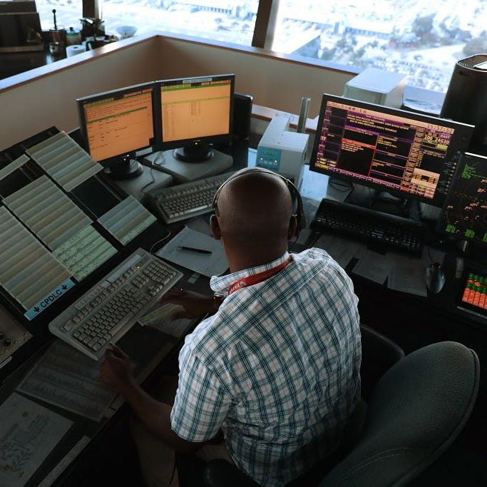 Air traffic controller Emil Watson uses data communications to  communicate with pilots, part of the Federal Aviation Administration's Next Generation Air Transportation system in the control tower at Miami International Airport on March 6, 2017 in Miami, Fla.