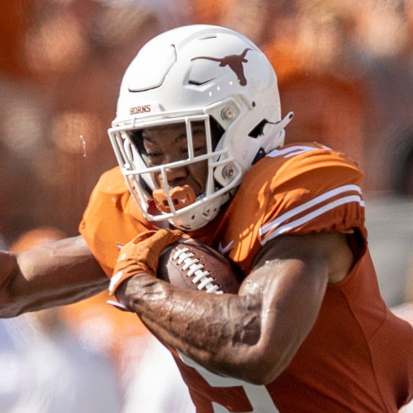 Texas running back Bijan Robinson tries to get past Louisiana's Bralen Trahan (left) and Brandon Bishop in the second quarter at Royal-Memorial Stadium on Sept. 4, 2021.