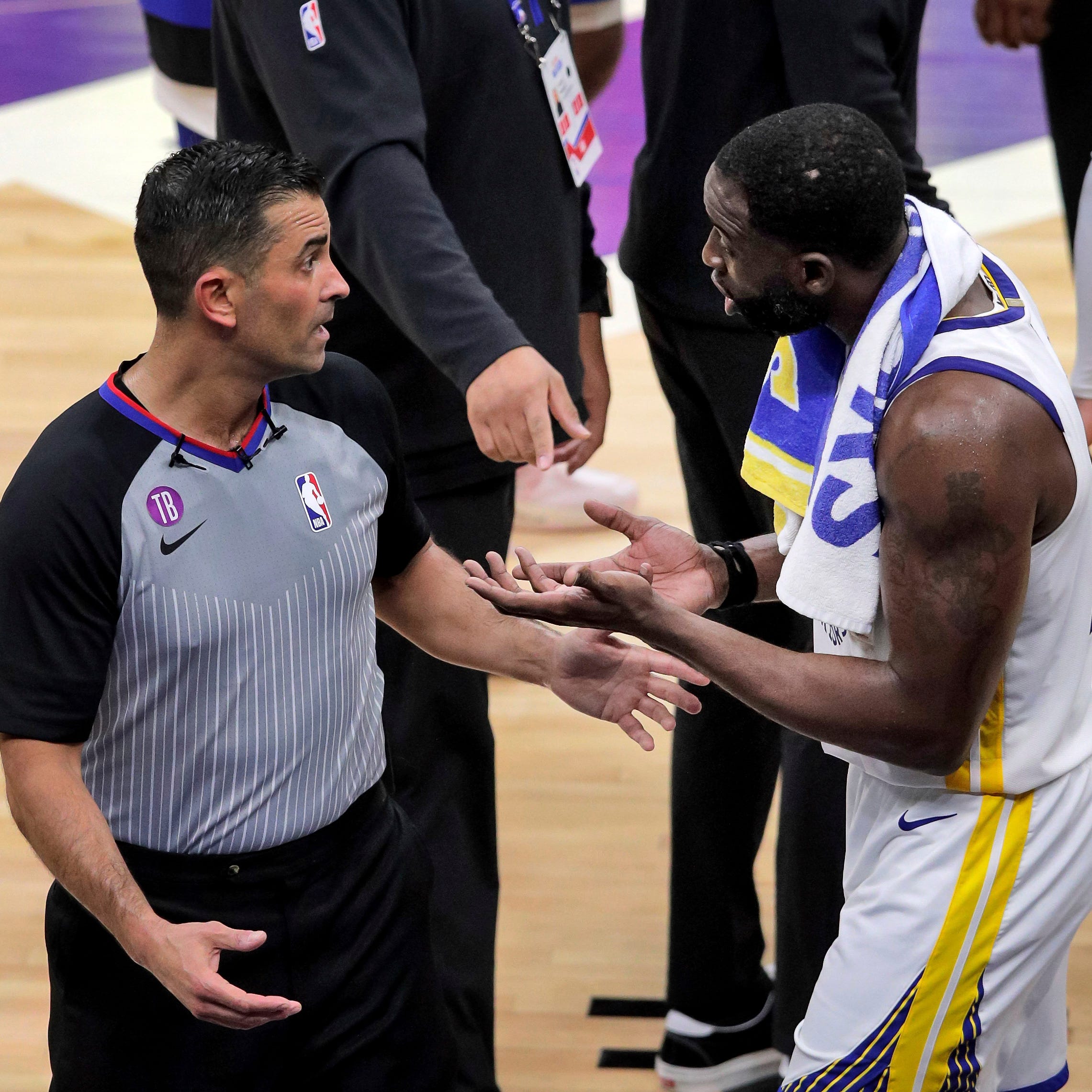 Golden State's Draymond Green makes his case with a referee as he learns he's been ejected after stomping on Domantas Sabonis.