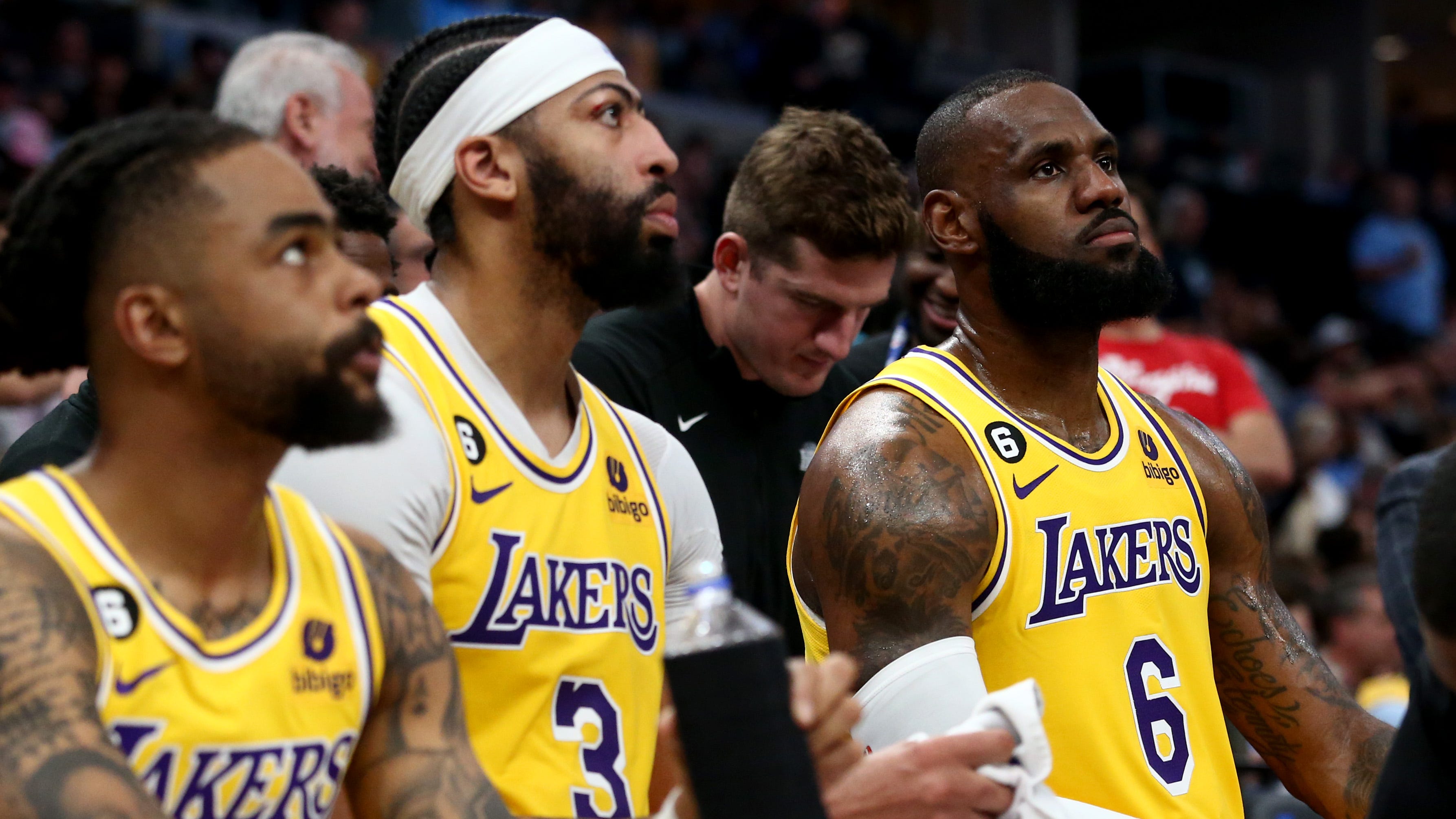 The Lakers' D'Angelo Russell, Anthony Davis and LeBron James sit on the bench during a timeout in Game 2.