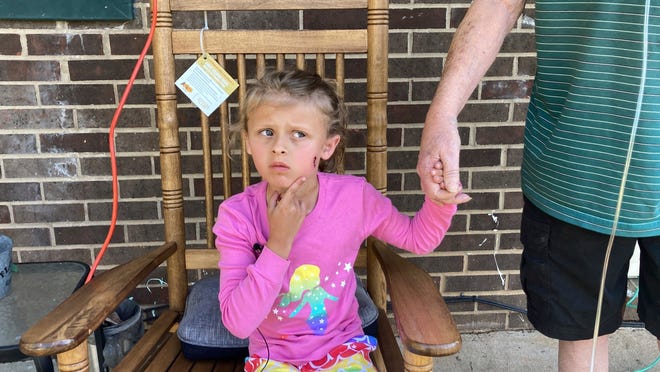 Kinsley White, 6, shows reporters a wound left on her face, Thursday, April 20, 2023 in Gastonia, N.C. A North Carolina man shot and wounded her and her parents after children went to retrieve a basketball that had rolled into his yard, according to neighbors and the girl's family — another in a string of recent shootings sparked by seemingly trivial reasons.