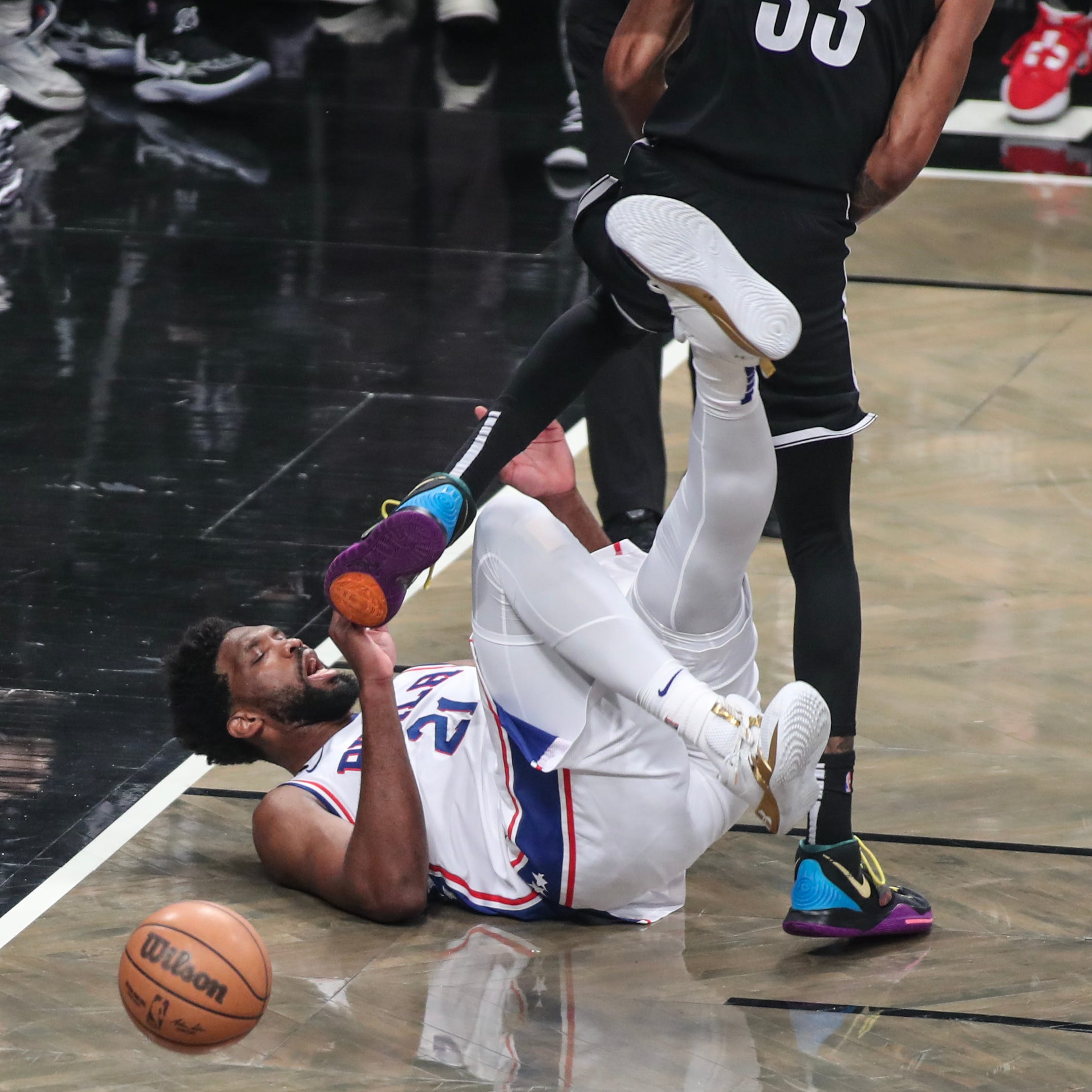 Game 3: The Philadelphia 76ers' Joel Embiid (21) falls to the floor after colliding with the Brooklyn Nets' Nic Claxton during the first quarter at Barclays Center on April 20.