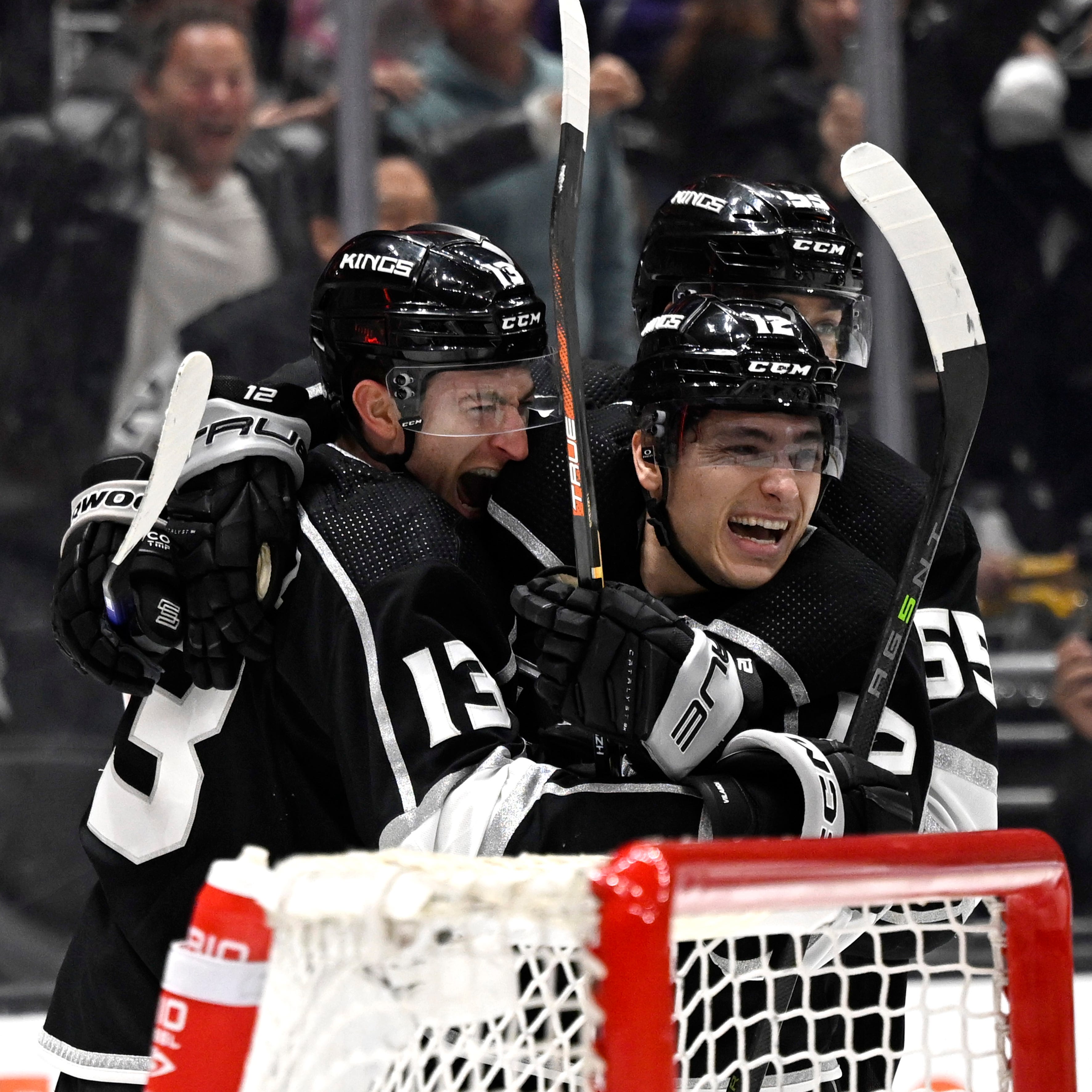Los Angeles Kings left wing Trevor Moore (12) celebrates with right wing Gabriel Vilardi (13) and center Quinton Byfield (55) after scoring the winning goal in overtime of Game 3 of their playoff series against the Edmonton Oilers.