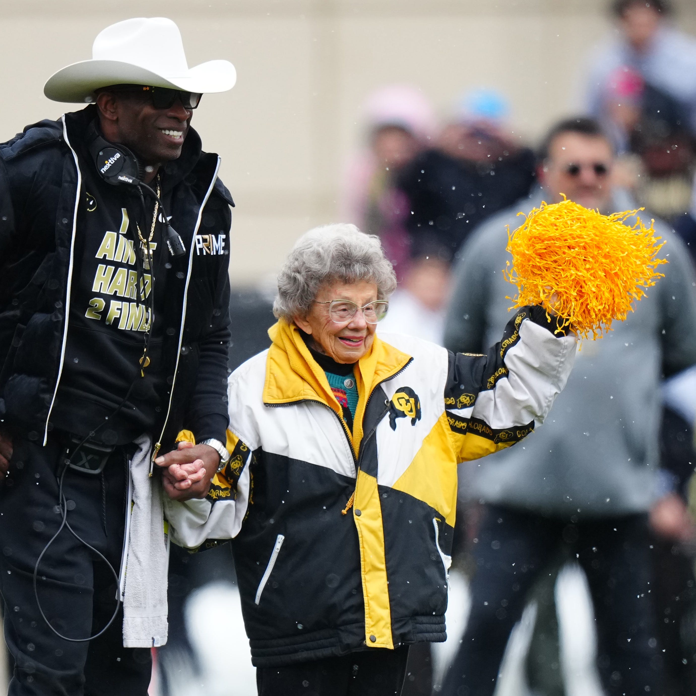 Apr 22, 2023; Boulder, CO, USA; Colorado Buffaloes head coach holds the hand of fan Peggy Coppom before the start of the spring game at Folsom Filed.
