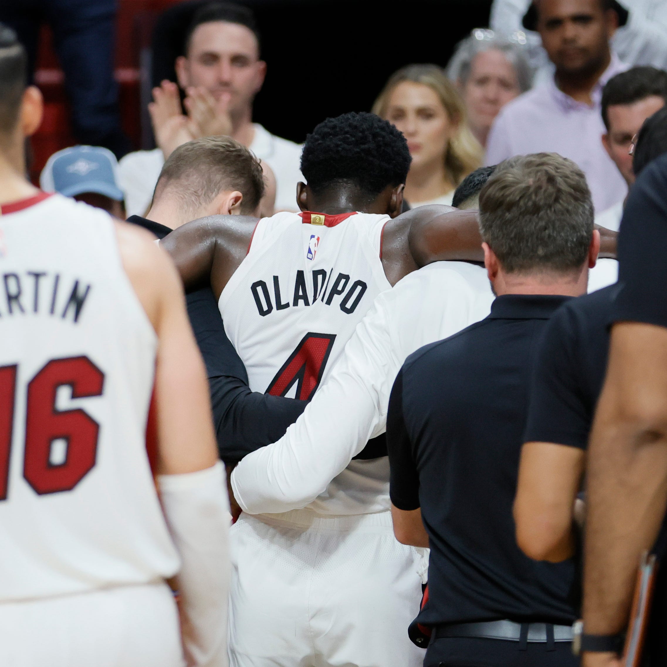 Miami Heat guard Victor Oladipo is helped off the court in the fourth quarter against the Milwaukee Bucks.