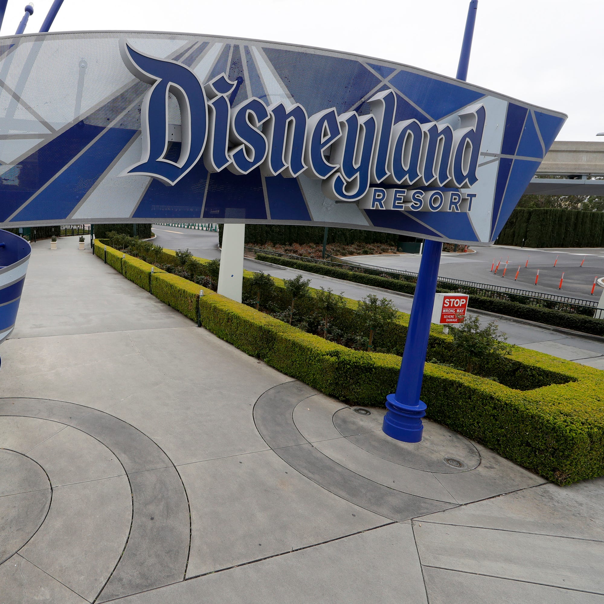 In this file March 18, 2020, file photo of one of the normally bustling entrances to the Disneyland resort is vacant due to the coronavirus closure in Anaheim, Calif.