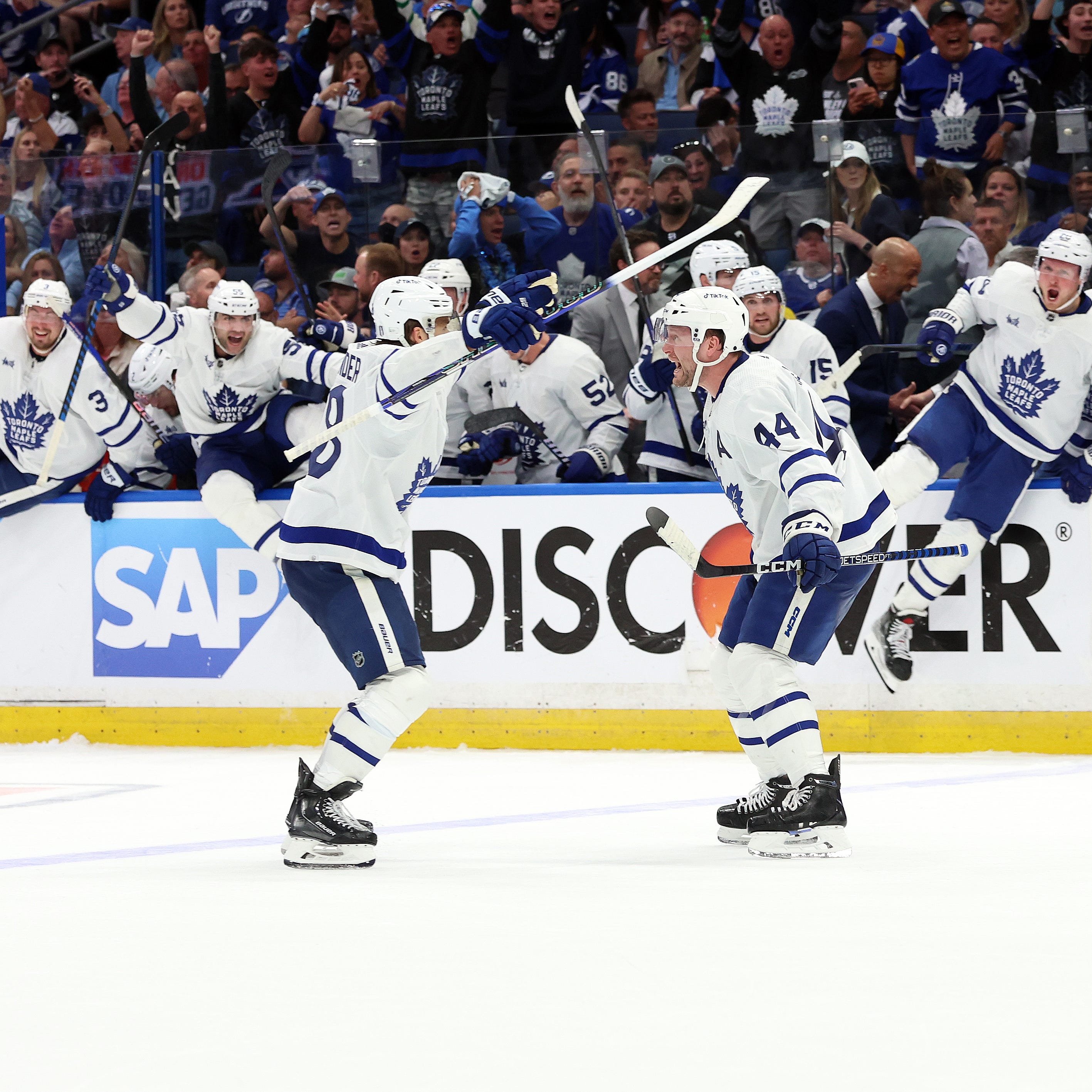 Toronto Maple Leafs defenseman Morgan Rielly (44) is congratulated by teammates after his overtime goal.