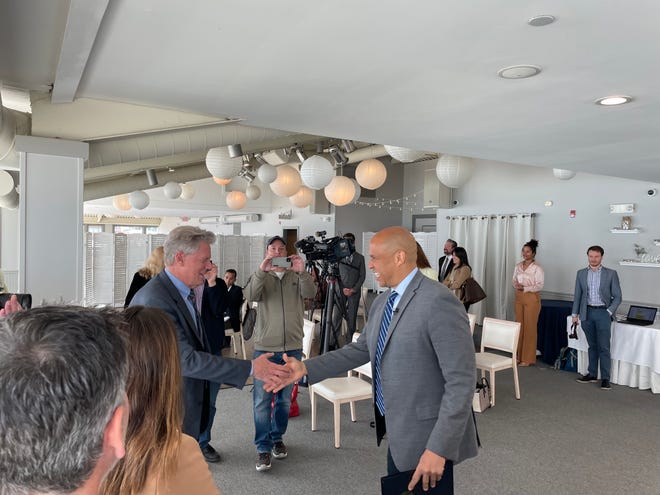 Rep. Frank Pallone Jr., left, shakes hands with Sen. Cory Booker in Long Branch on April 24, 2023.