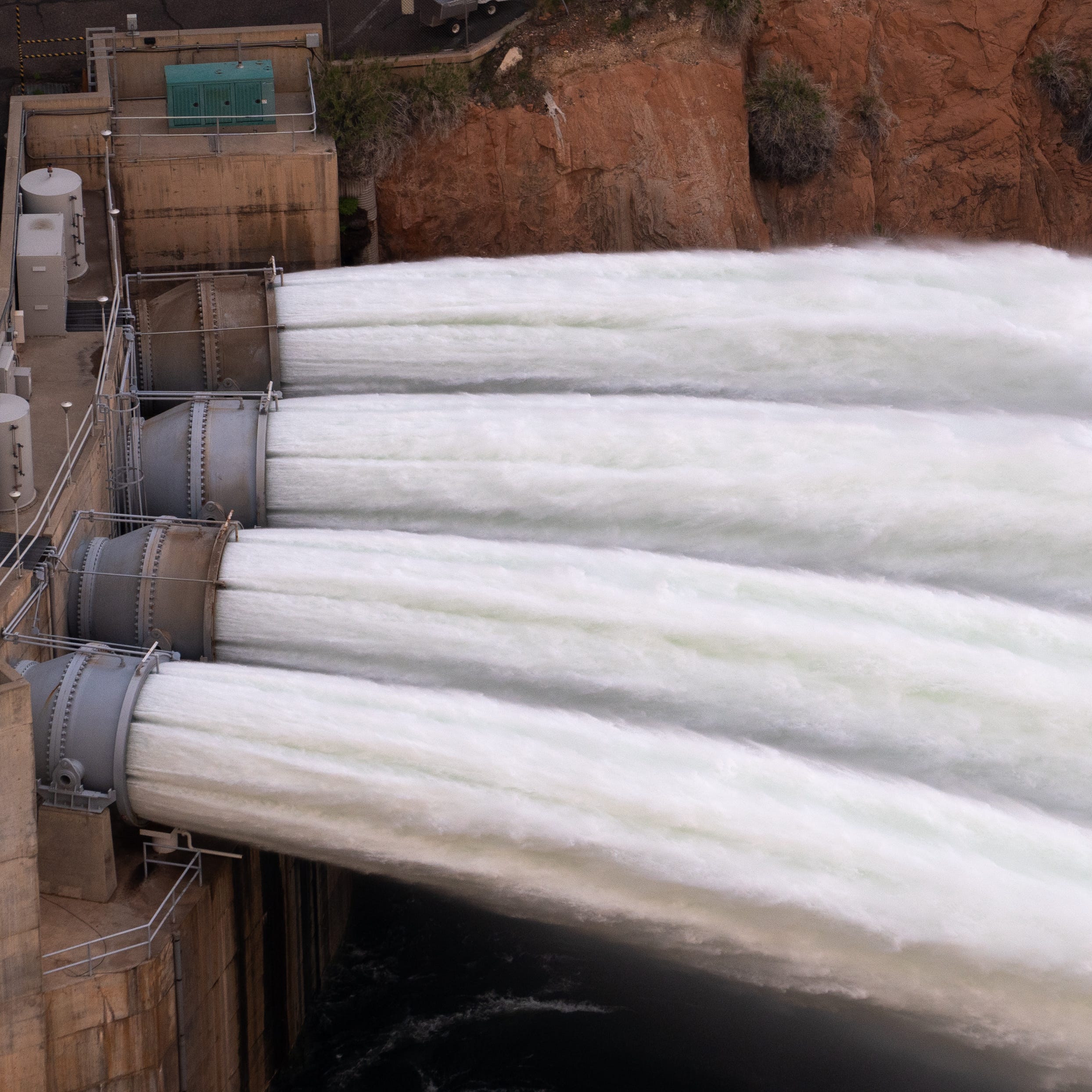 Water is released from Glen Canyon Dam through bypass tubes on April 24, 2023, during a high-flow experiment. The flood will help move sand and sediment down the Colorado River the way the river's natural flows did before the construction of Glen Canyon Dam in Page, Ariz.