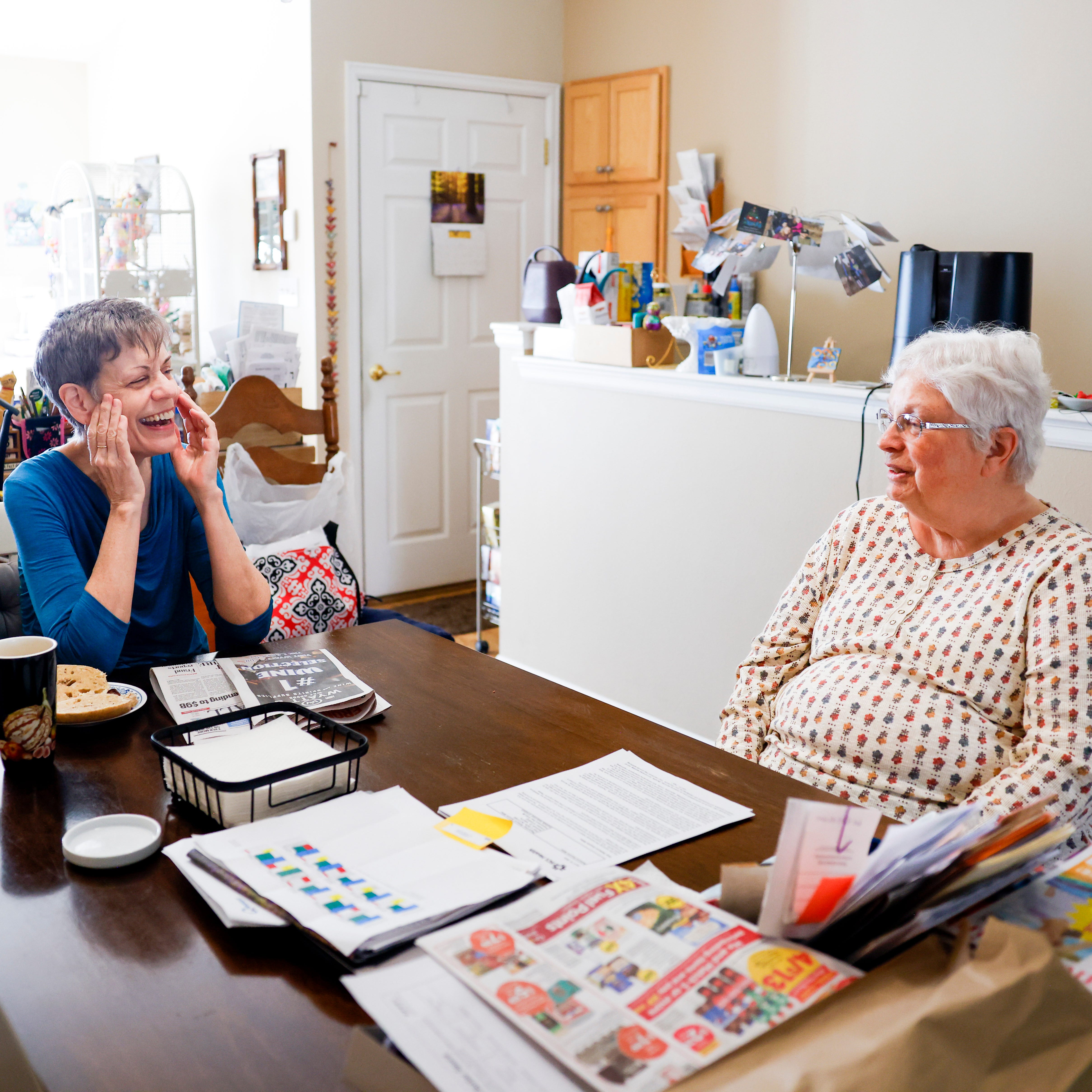 Marlene Mears, left, and Becky Miller, right, chat at their kitchen table in Longmont, Colo. Mears has been a tenant at Miller's home for over two years.