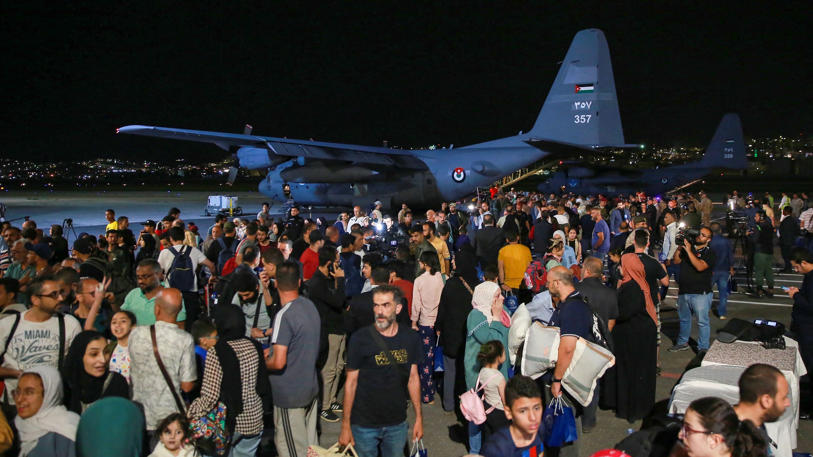 People evacuated from Sudan arrive at a military airport in Amman on April 24, 2023. Foreign countries rushed to evacuate their nationals from Sudan as deadly fighting raged into a second week between forces loyal to two rival generals.