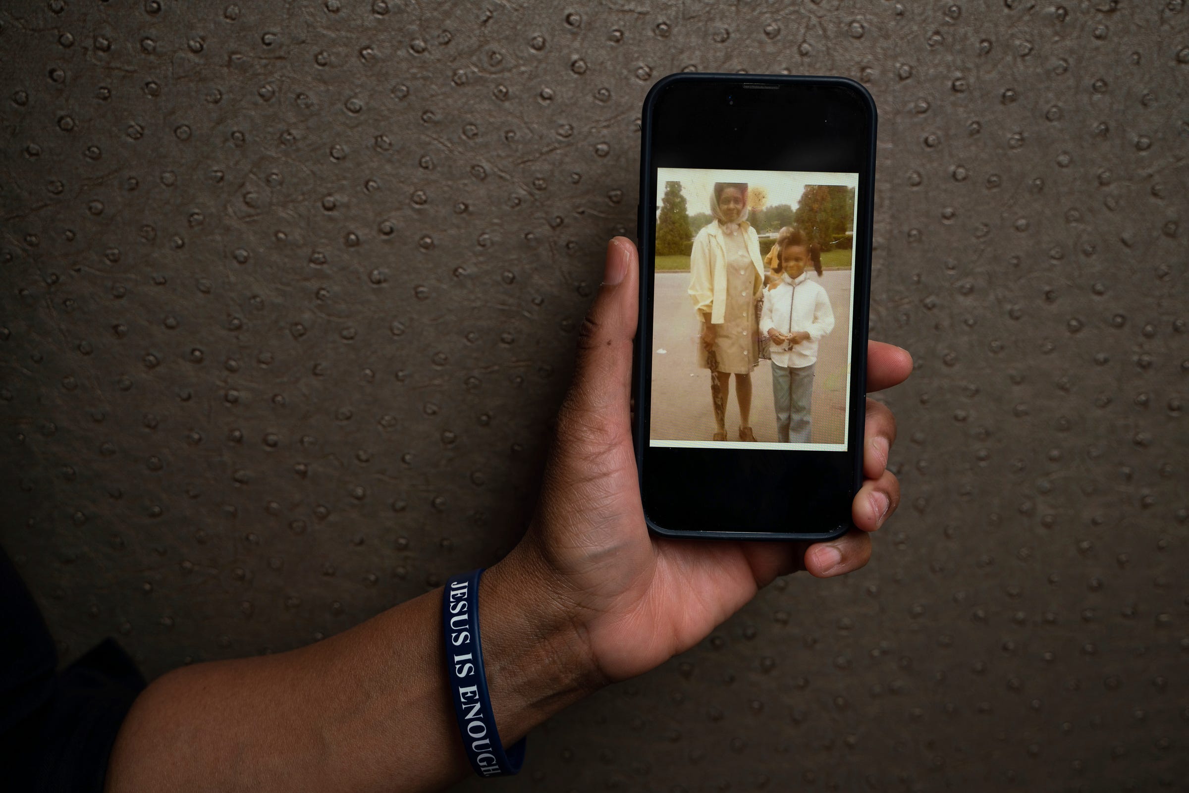 Yulanda Harris, 63, holds a childhood photograph of herself around age 10 standing beside her mother, at Michigan Design Center in Troy on Friday, April 7, 2023. "There was never any question. I knew I was different. My brain operated on a different scale," said Harris, who was diagnosed with autism at age 58. "It really felt like a sense of relief. I've masked so much for so long, I really didn't know who I was."