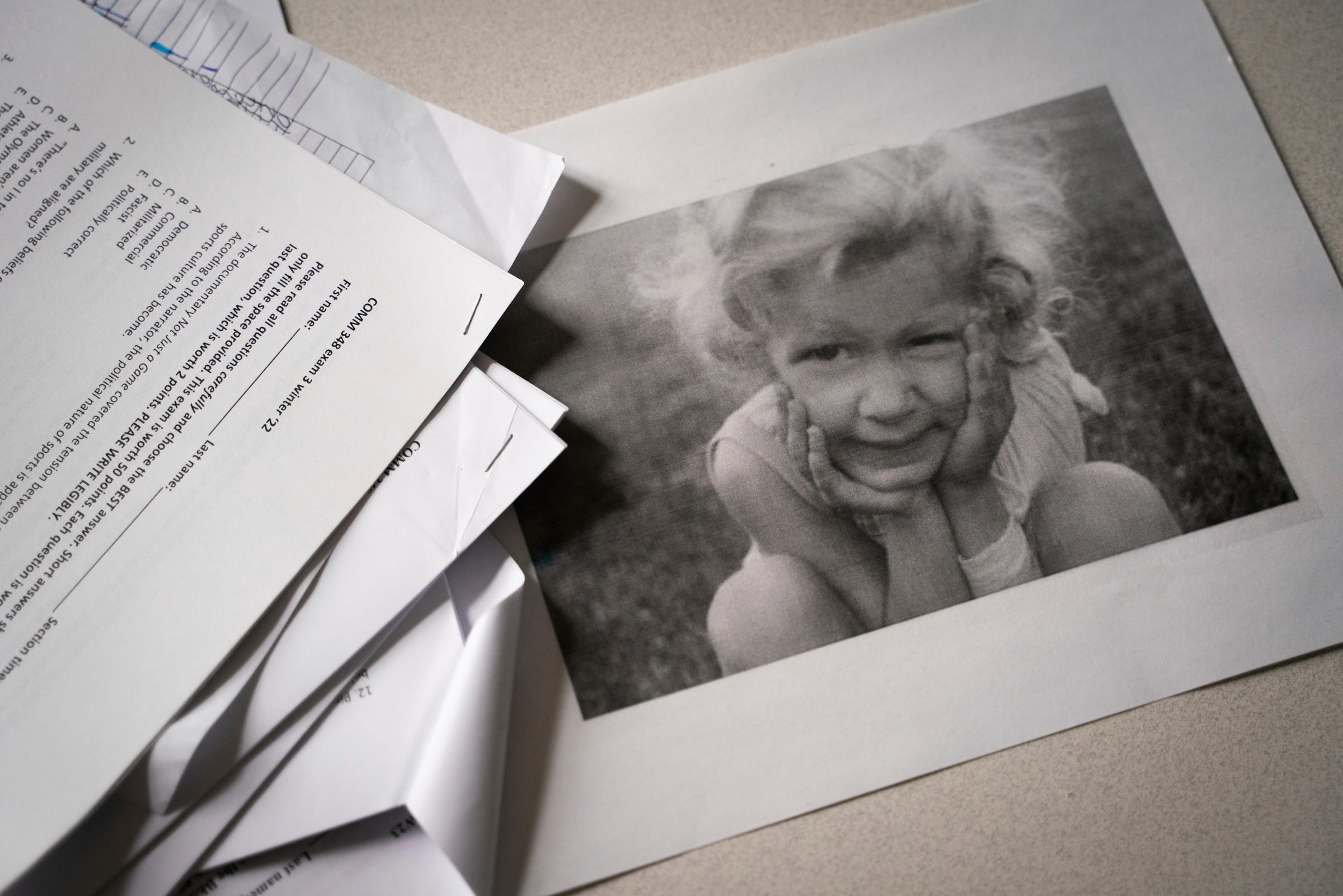 A childhood photograph of Kris Harrison around the age of 4, sits on the desk inside her office at University of Michigan in Ann Arbor on Monday, April 3, 2023. "I got it drilled in my head from a very young age, 'you're too sensitive, you're being a prima donna, you don't have a right to ask for accommodation, you need to shape shift yourself to the way the world is.' "I think some of that is generational," said Harrison, who was diagnosed in her 30's with Asperger Syndrome, which is now part of a broader category called Autism Spectrum Disorder (ASD). "It was just 'oh she's a weird kid. She's a tomboy.' Nobody would have ever said autism at that time."