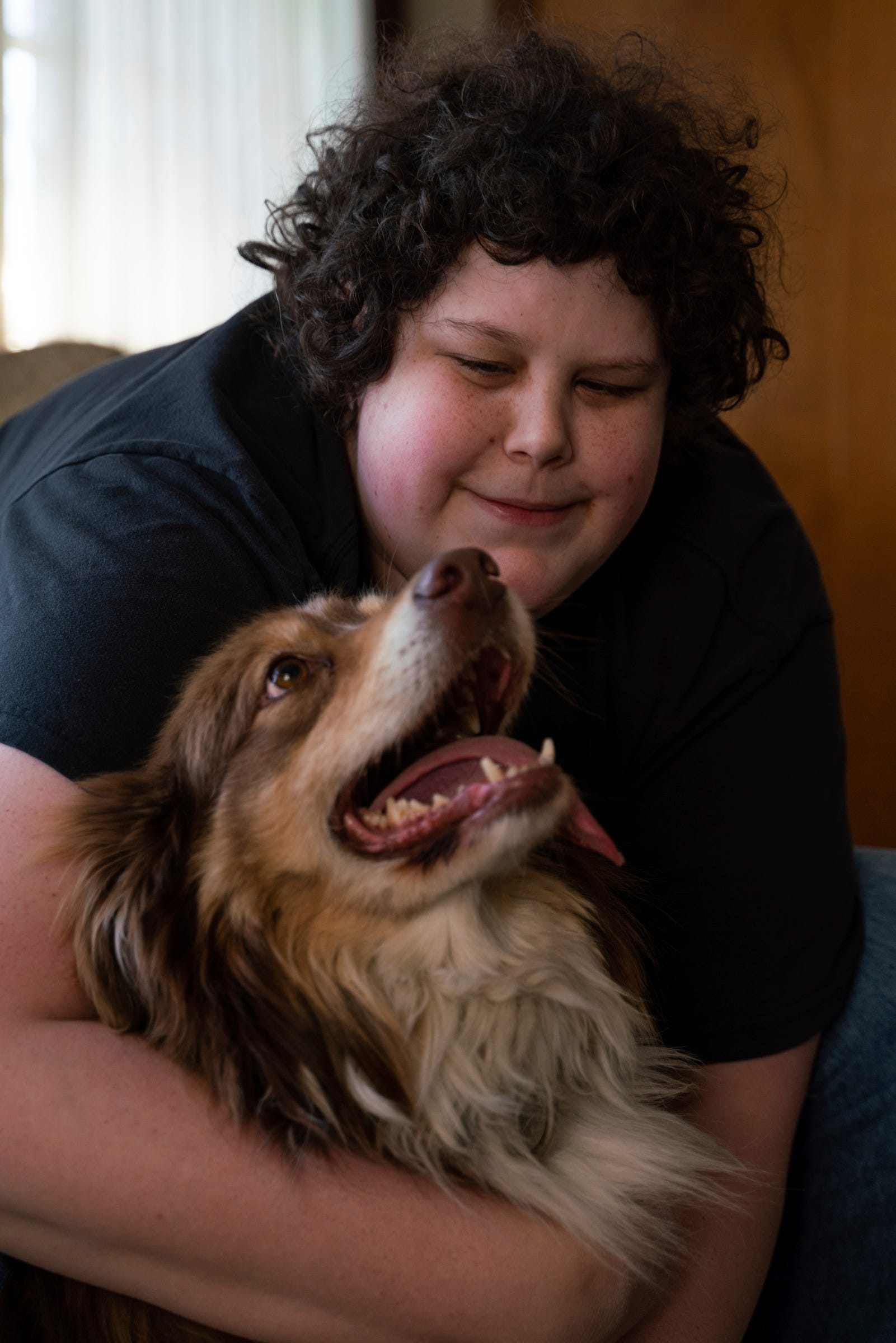 Joe Alice, 30, sits with his dog named Mark at his home in Southgate on Friday, April 7, 2023. "I don't even have any friends except my dog. ItÕs been hard," said Alice, who enjoys public speaking, learning about autism, and considers himself a huge western fan. "If I'm stressed out or having a panic attack I'll pet him, hug him, or talk to him and he'll calm me down. Even when he just smiles. He opens up his mouth and it looks like a smile and it just melts me and makes me feel so much better."