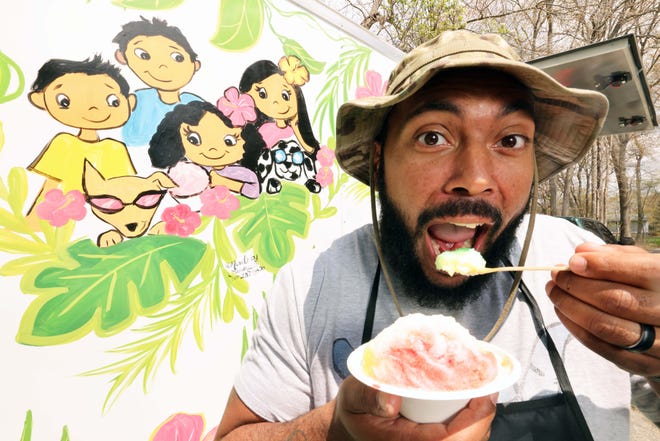 Alex Burrell, co-owner of That's So Cool Shave Ice in Brockton, tastes one of his shaved ice masterpieces.
