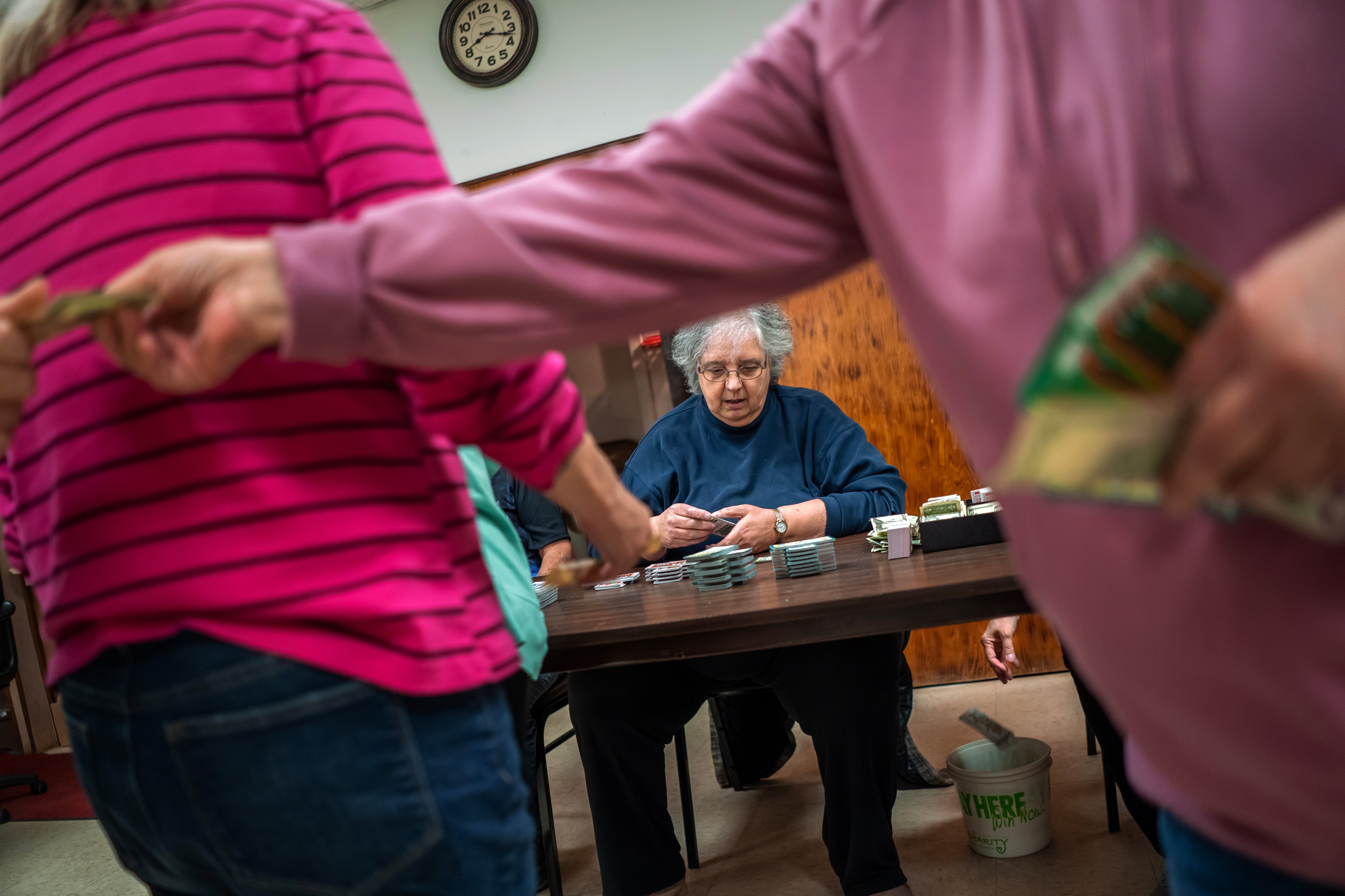 Barb Lusardi, center, of Ishpeming, works on collecting money as a group of women line up to purchase lottery-style game tickets during intermission at the bingo she runs at the Odd Fellows' lodge in Ishpeming on Friday, Feb. 10, 2023, in Michigan's Upper Peninsula.