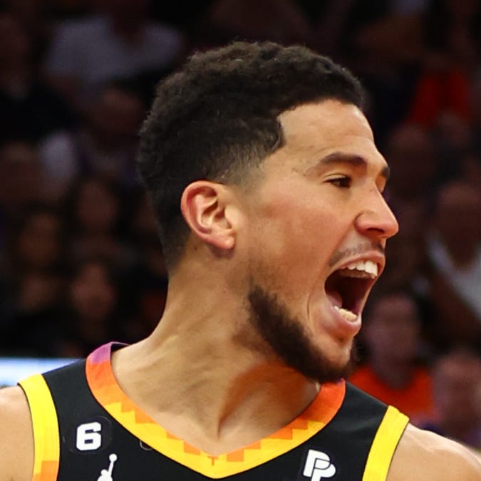 Phoenix Suns guard Devin Booker celebrates after dunking the ball against the Los Angeles Clippers in Game 5 of their playoff series at Footprint Center.
