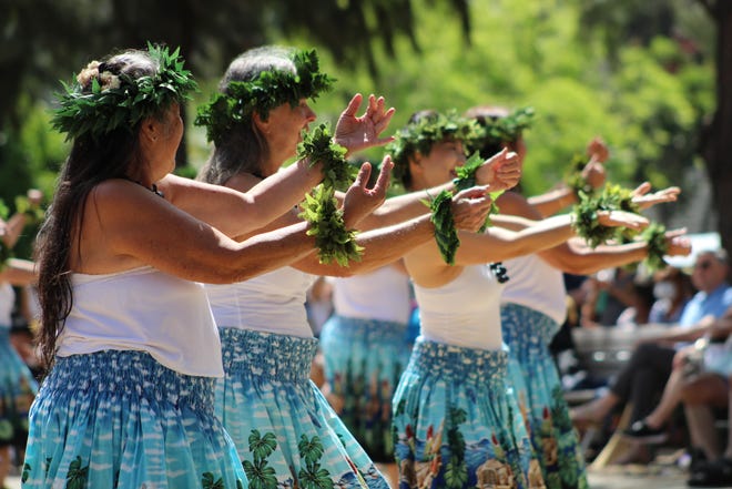 Hula dancers wearing leis perform at Lei Day Celebration in 2022.