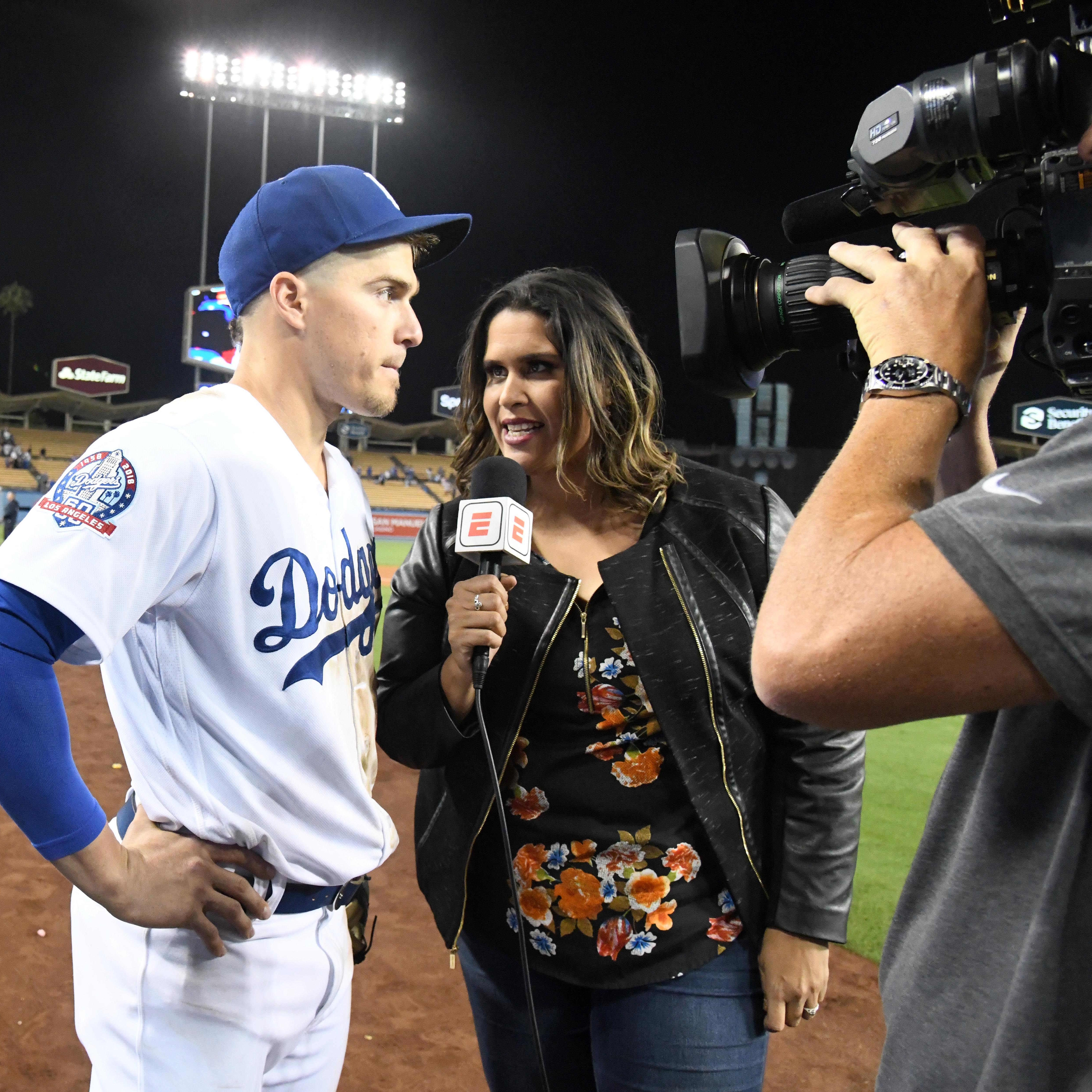 Los Angeles Dodgers shortstop Kike Hernandez (left) is interviewed by ESPN Deportes broadcaster Marly Rivera after the game against the Chicago Cubs at Dodger Stadium on Jun 25, 2018.