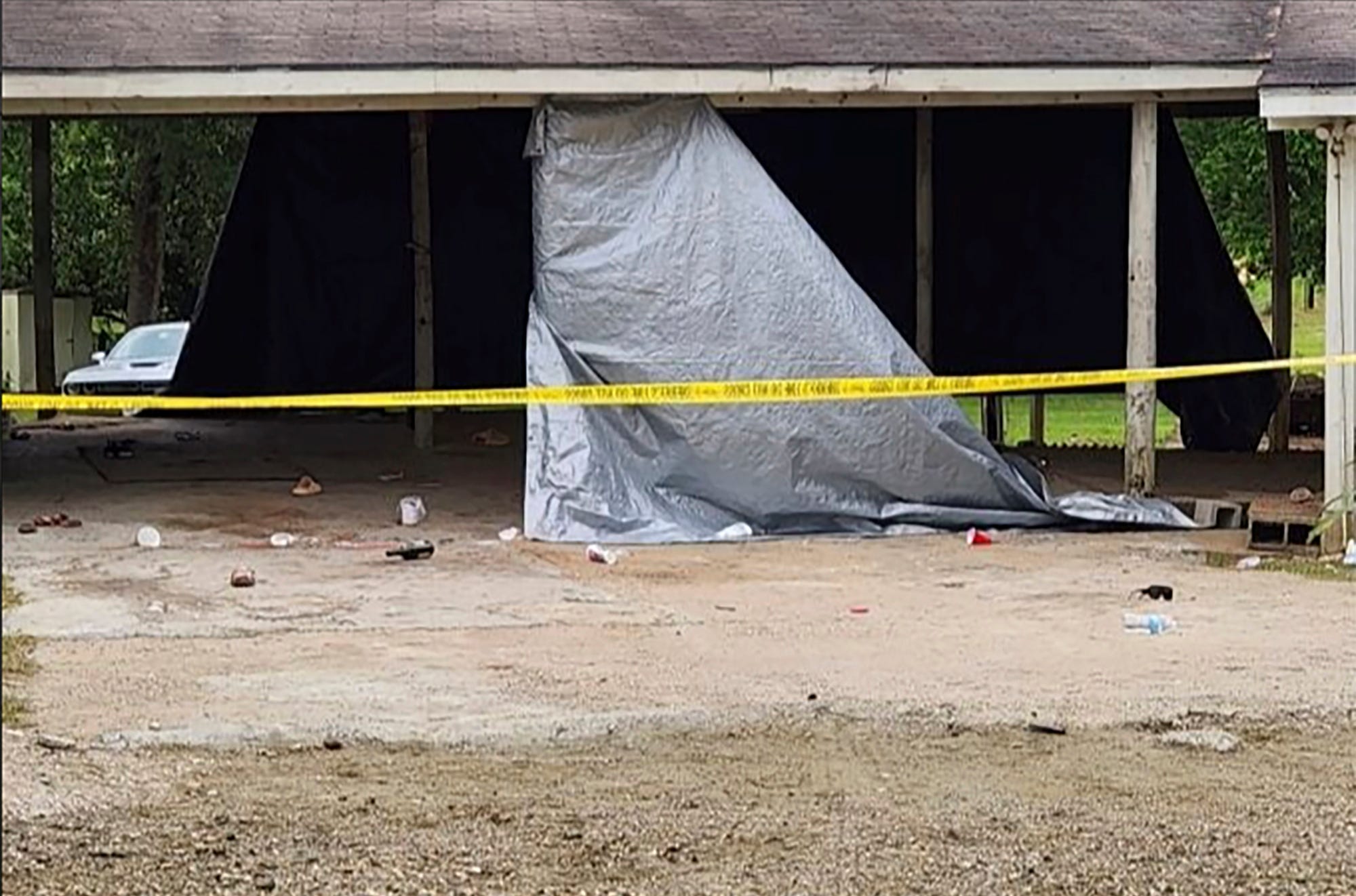 Jasper, Texas, crime scene tape cordons off the scene of a shooting, Sunday, April 23, 2023, in Jasper, Texas. Officials said gunfire at a huge prom after-party at the home injured multiple teenagers, and a second shooting in a nearby city is being investigated for a possible connection.