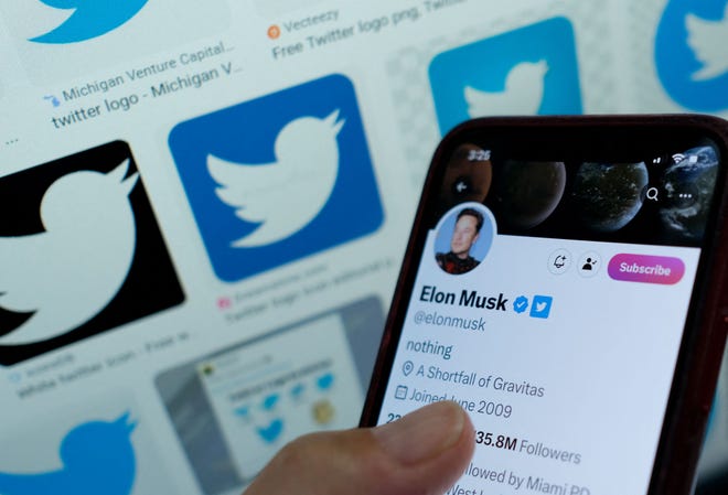 Elon Musk's blue checkmark next to his name on a smartphone.