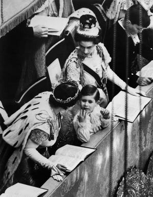 In this file photo taken on June 2, 1953 at London, in the Westminster abbey Prince Charles reacts during the coronation ceremony of his mother, Queen Elizabeth II. Trained from childhood to be king, Charles III has endured the longest wait for the throne in British history. He has spent virtually his entire life waiting to succeed his mother. Their coronations, separated by 70 years, differ in style, size, tone and mission.