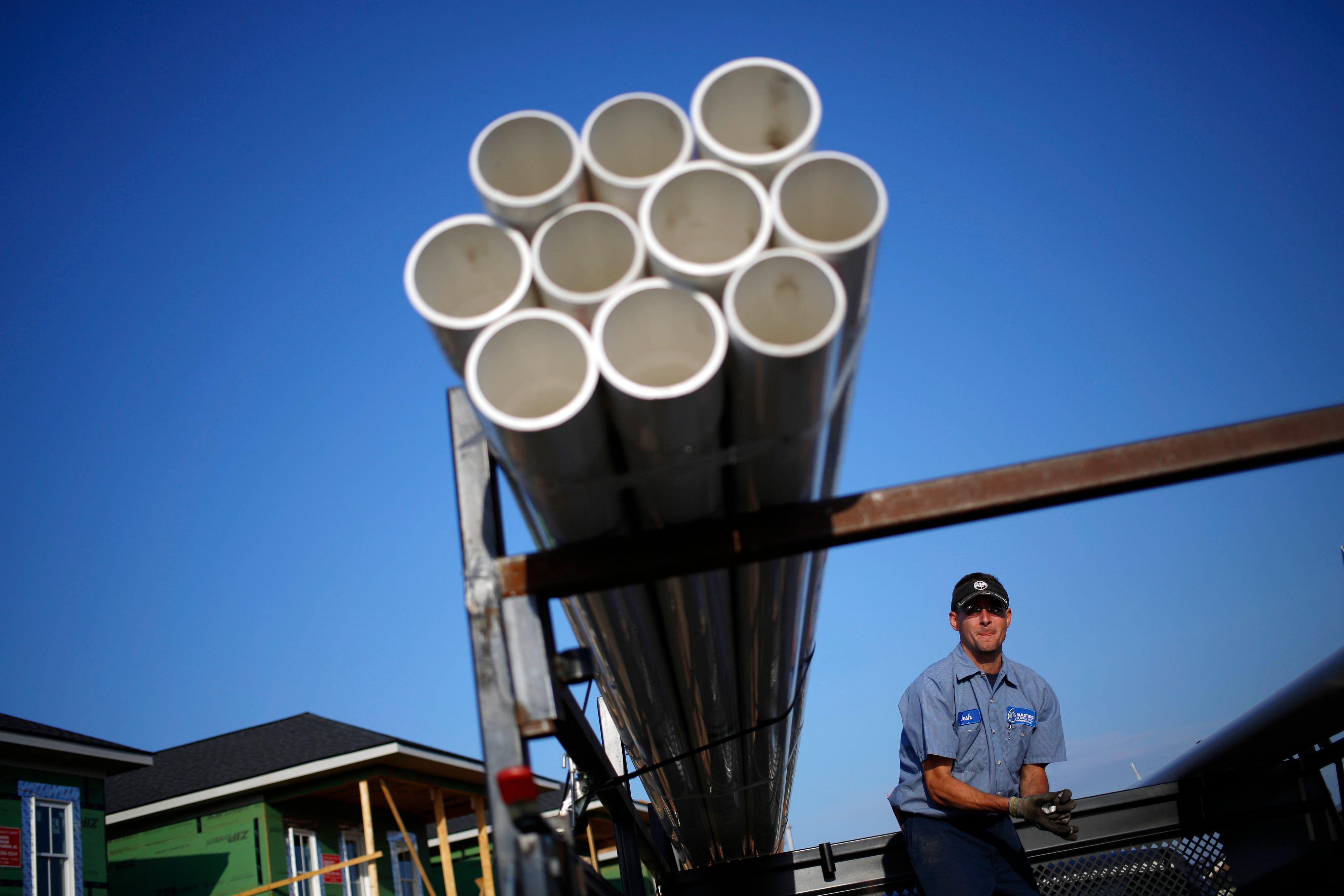 Truck driver Josh Switzer delivers PVC pipe to a residential housing lot under construction at the Norton Commons subdivision in Louisville, Kentucky, U.S. on Tuesday, May 13, 2014. The U.S. Census Bureau is scheduled to release monthly housing starts data on May 16. Photographer: Luke Sharrett/Bloomberg via Getty Images